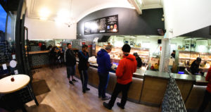 Customers queuing inside a shop