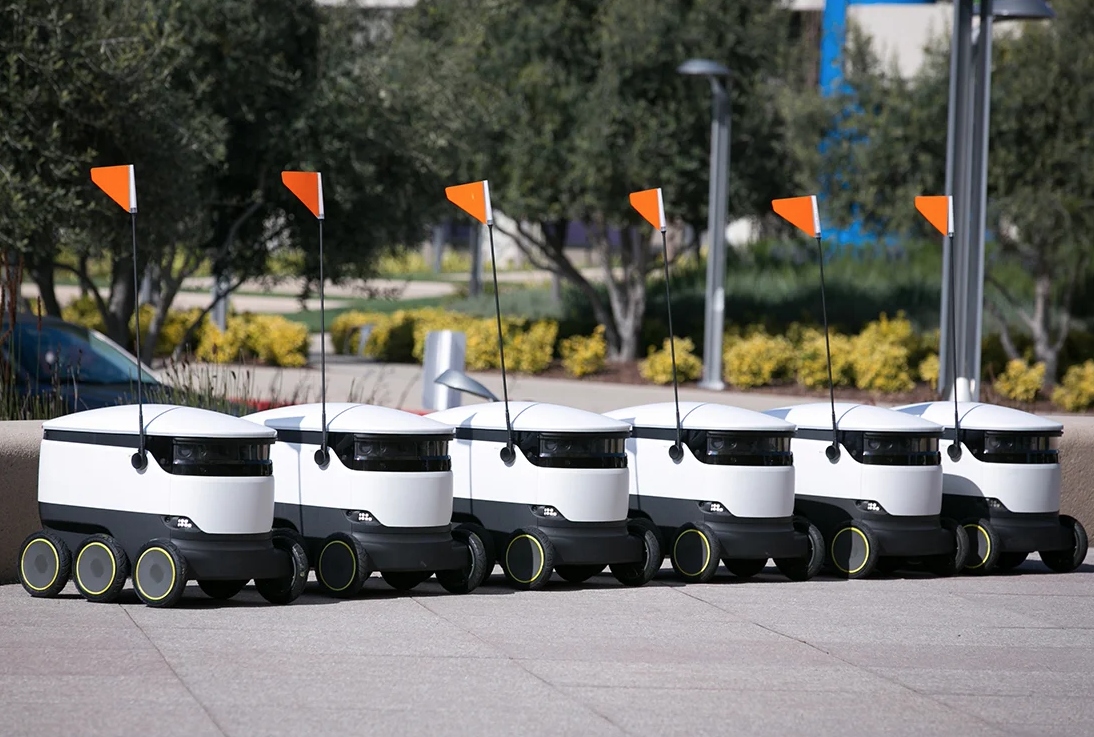 Image of self driving robots lined up and ready to deliver takeaway