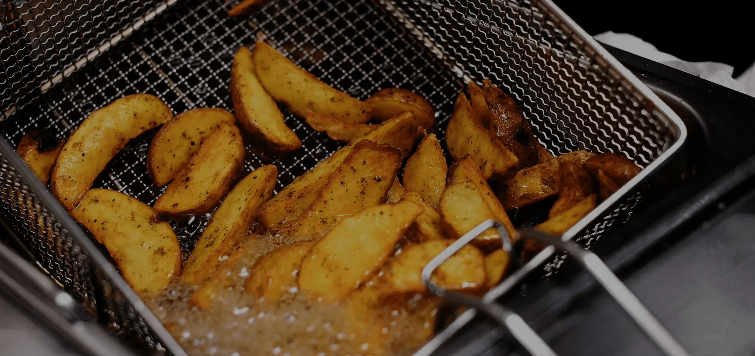 Wedges being fried in pan