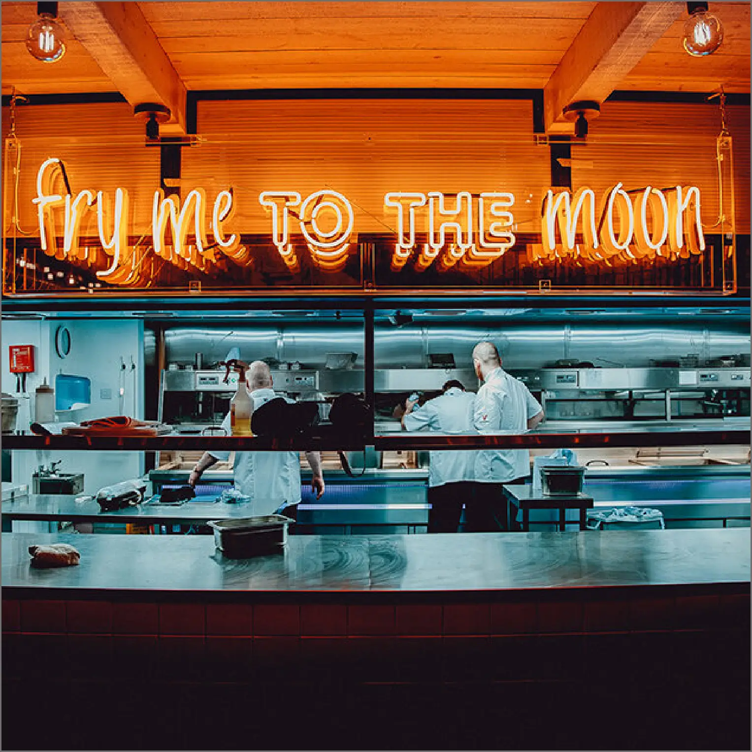 Kitchen with neon decorative writing 'fry me to the moon'