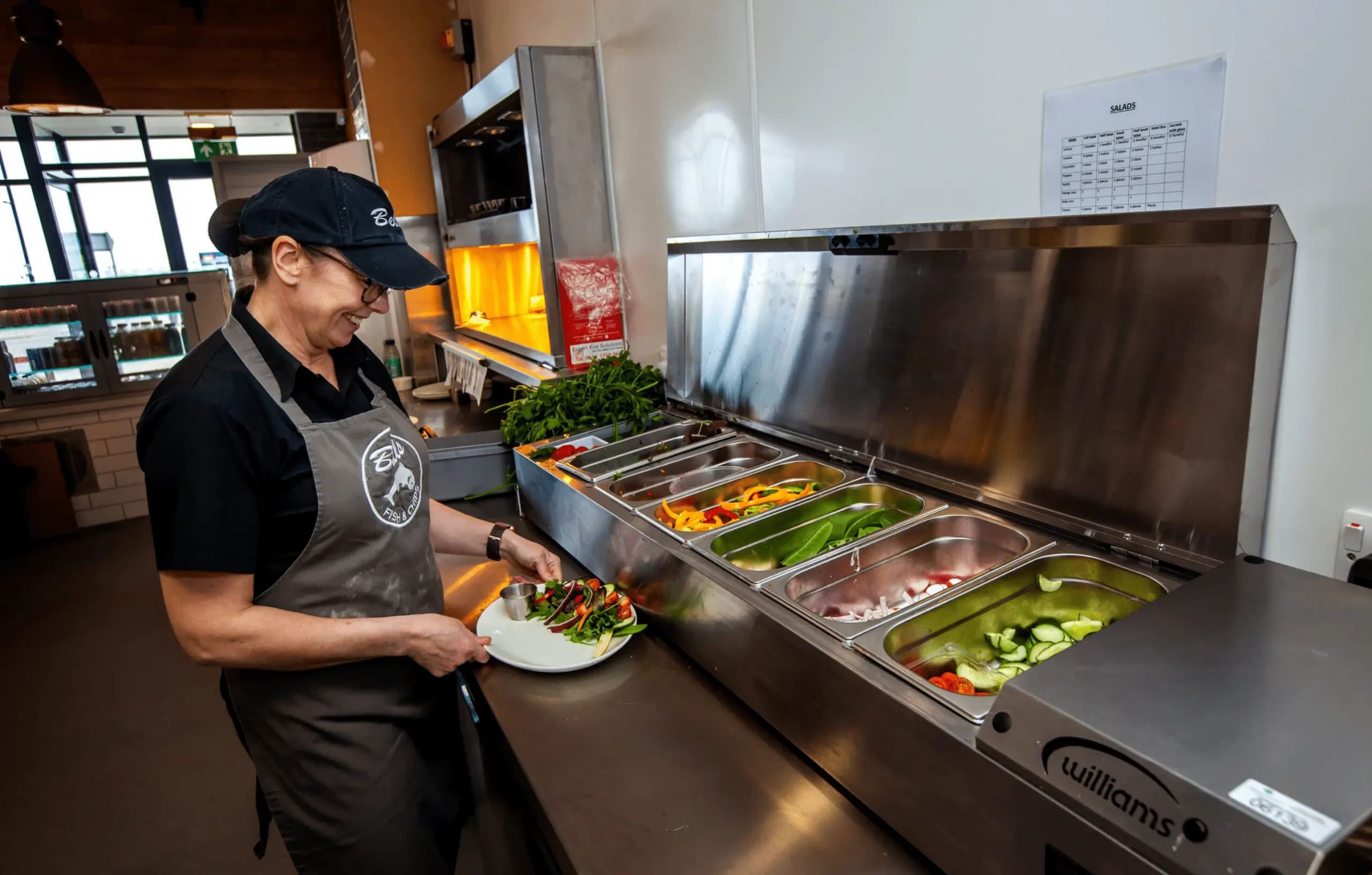 Cold food being served out of food counter tubs