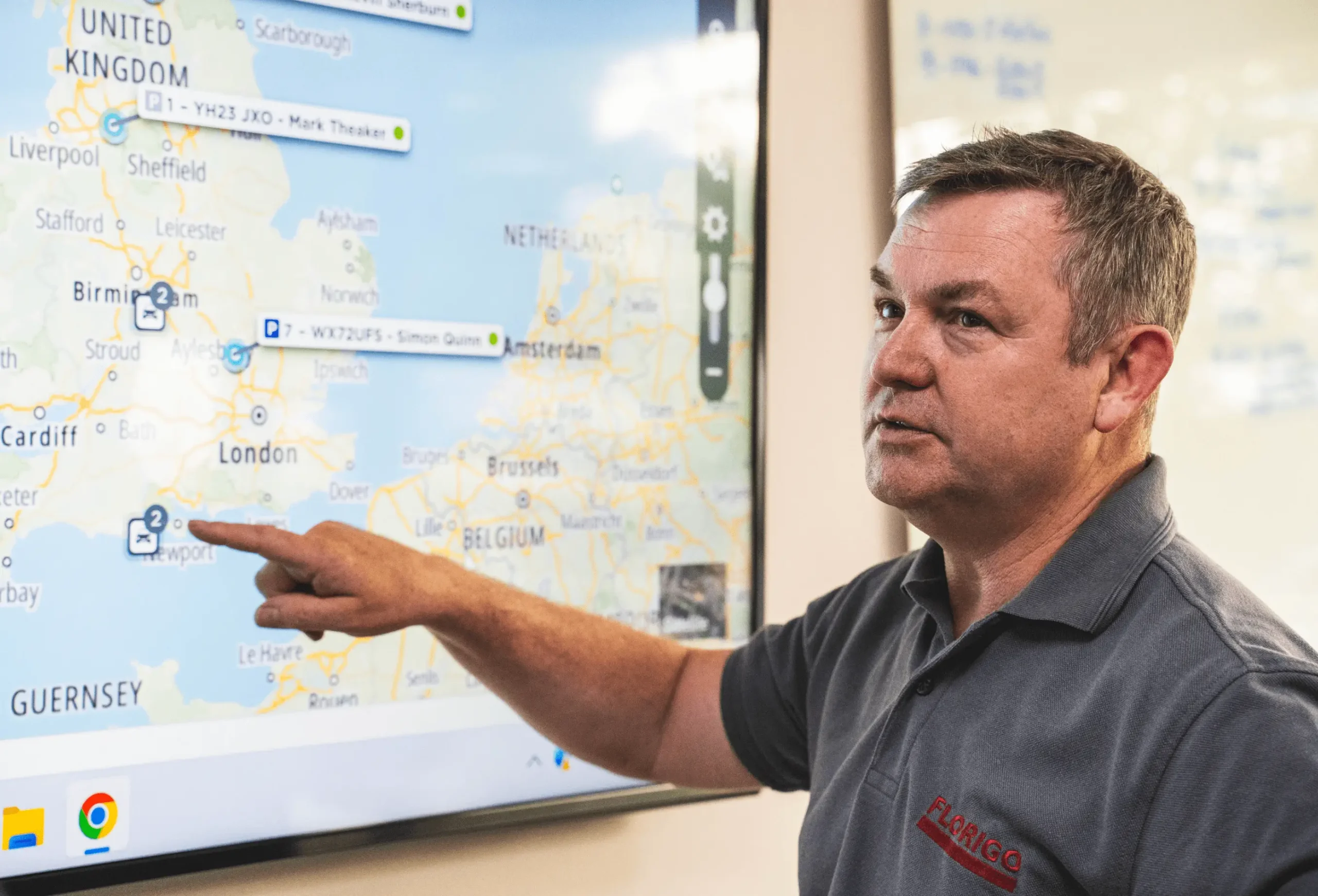 Man pointing at digital map on big screen