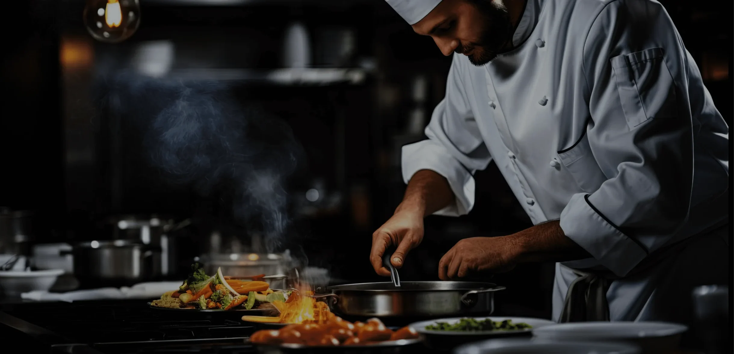 Chef in his uniform cooking food in a kitchen