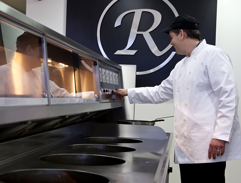 Man in chefs white pictured using Florigo Fryer