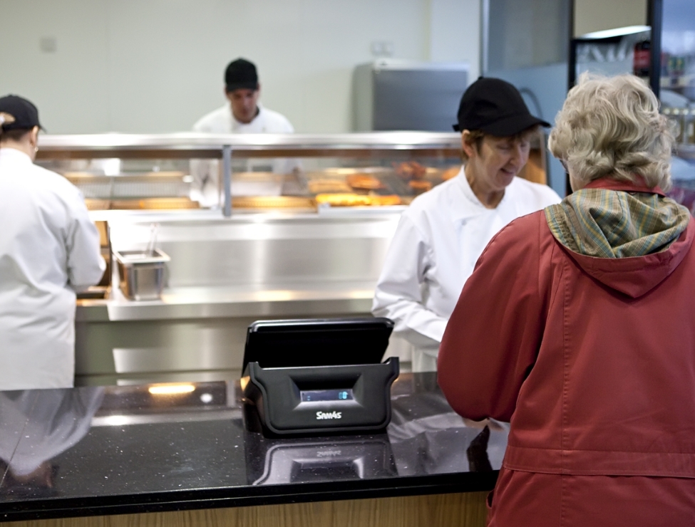 Customer being served by chef at a fish and chip shop